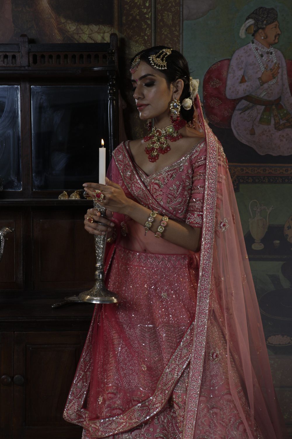 Photo of Bride in bright peach lehenga with green necklace